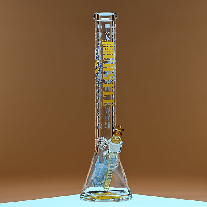 A glass bong with yellow accents, featuring the brand name Castle in bold yellow letters along with Egyptian hieroglyphics on the neck. It is set against a warm amber background that enhances the vibrant yellow details and the amber-tinted bowl and downstem. The clean lines of the glass and the intricate design elements are highlighted, creating a visually striking contrast against the simple, warm backdrop.