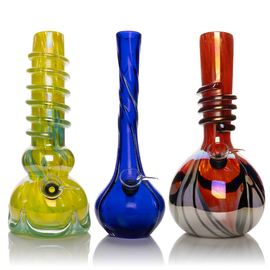 Three 10-inch retro glass bongs in yellow-green, cobalt blue, and amber-red, each with a sculpted chamber and long neck.