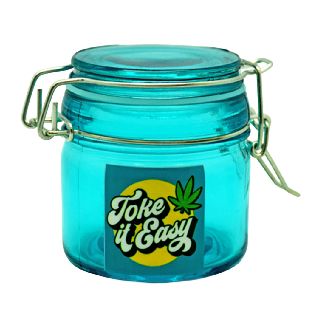 Toke It Easy Dank Tank Storage Jar - Transparent teal glass storage jar with a metal clamp lid and green “Toke It Easy” label.